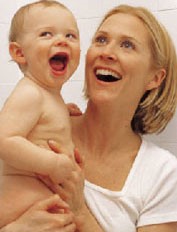 Joyful mother holding her laughing baby.