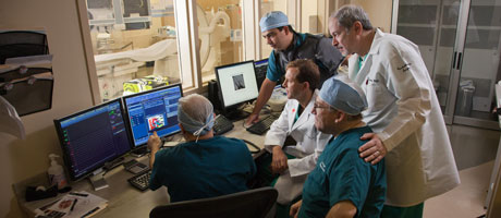 Doctors sitting around computer screen