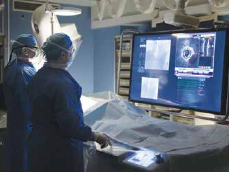 Cardiac Partners Interventional Cardiologists Janah Aji, MD, FACC, and Kurt W. Kaulback, MD, FACC, in the catheterization lab at Cooper University Hospital.